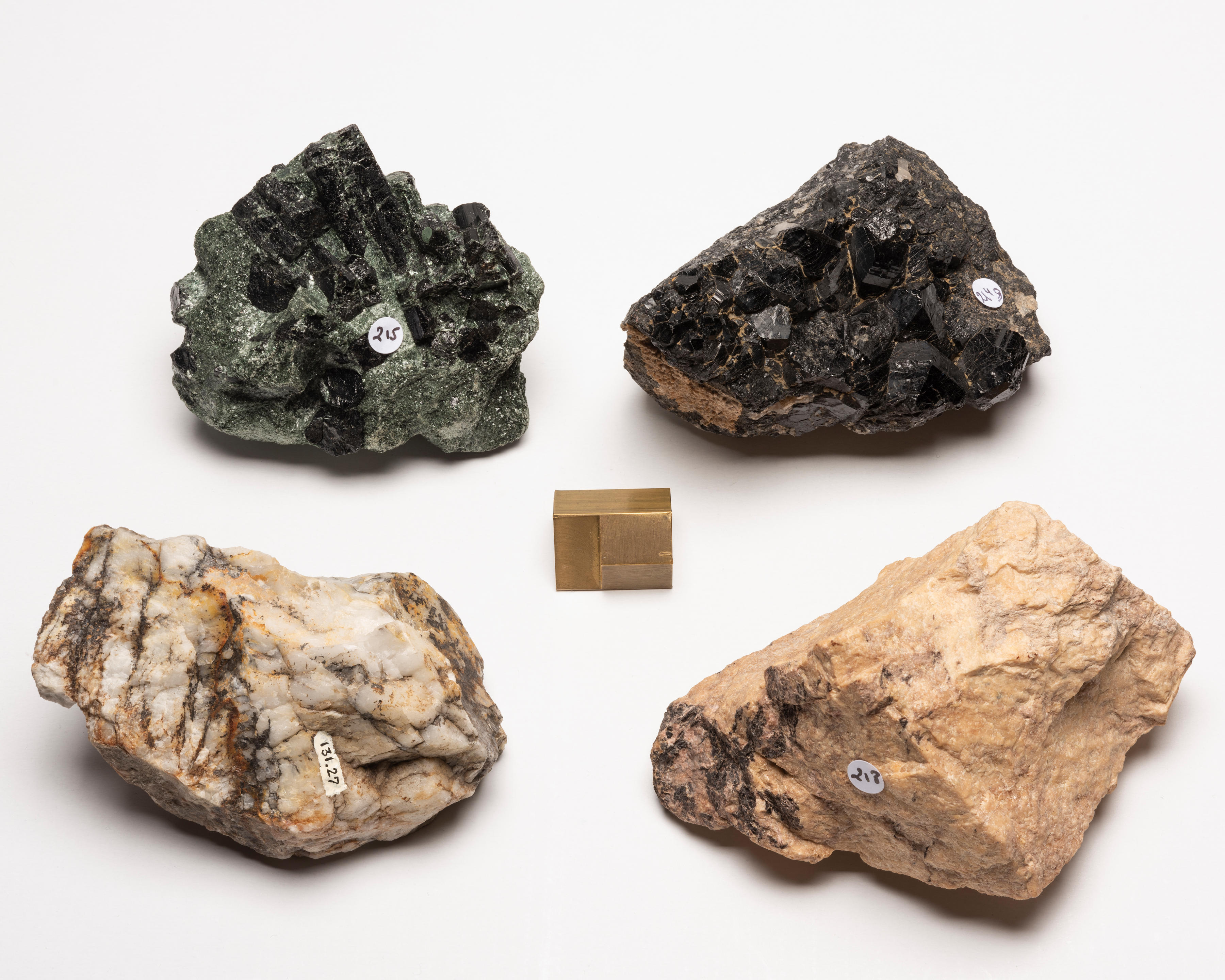 FOUR SPECIMENS TOPAZ FERROUS TOURMALINE SILLIMANITE AND AXINITE Topaz rather
