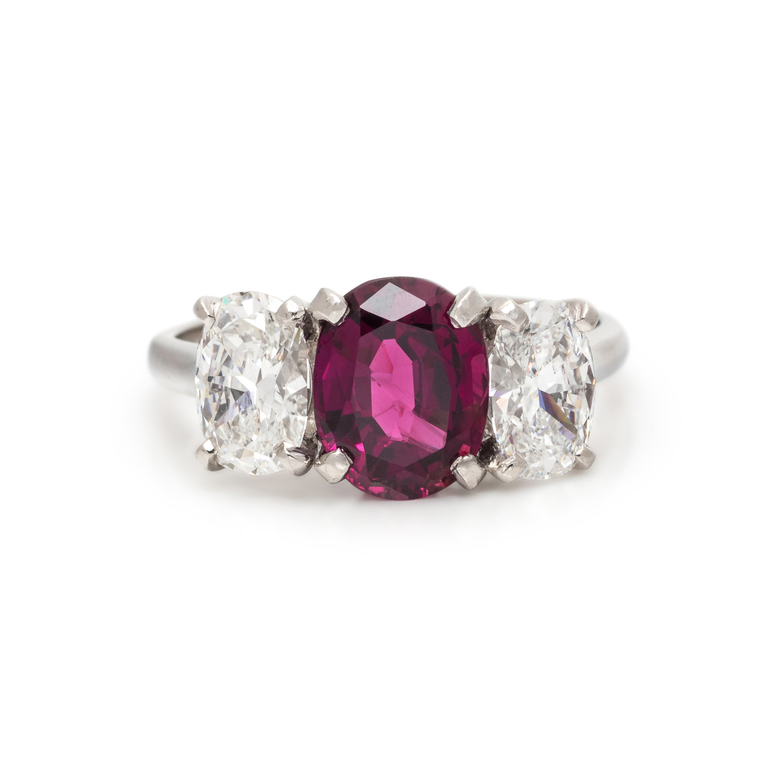 RUBY AND DIAMOND RING Containing one oval mixed cut ruby