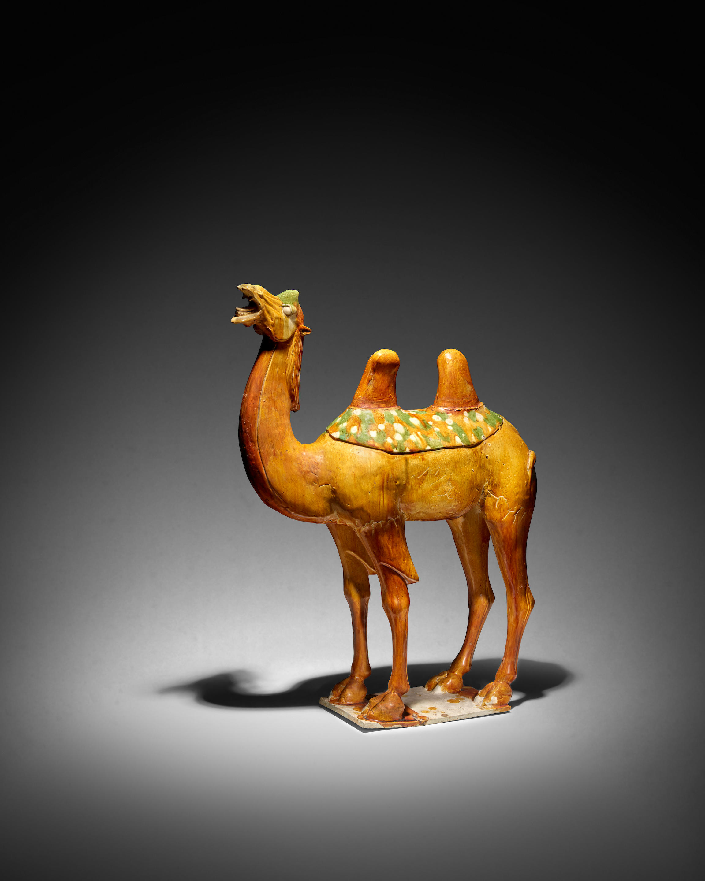 A SANCAI AND AMBER GLAZED POTTERY BACTRIAN CAMEL Tang Dynasty