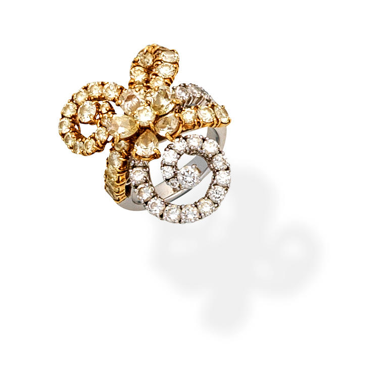 DIAMOND AND COLOURED DIAMOND DRESS RING Of floral and swirl