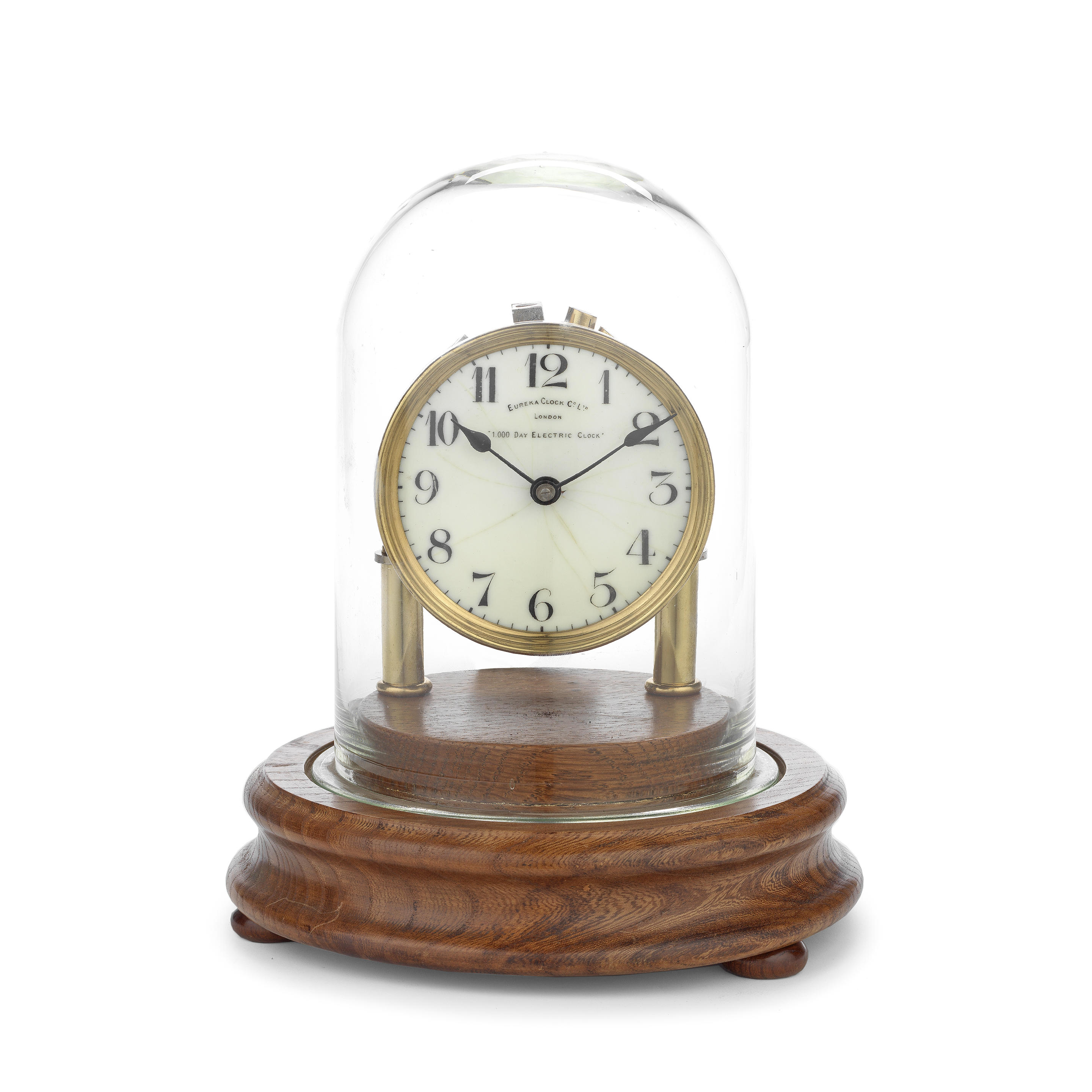 AN EARLY 20TH CENTURY BRASS AND ENAMEL EUREKA CLOCK the