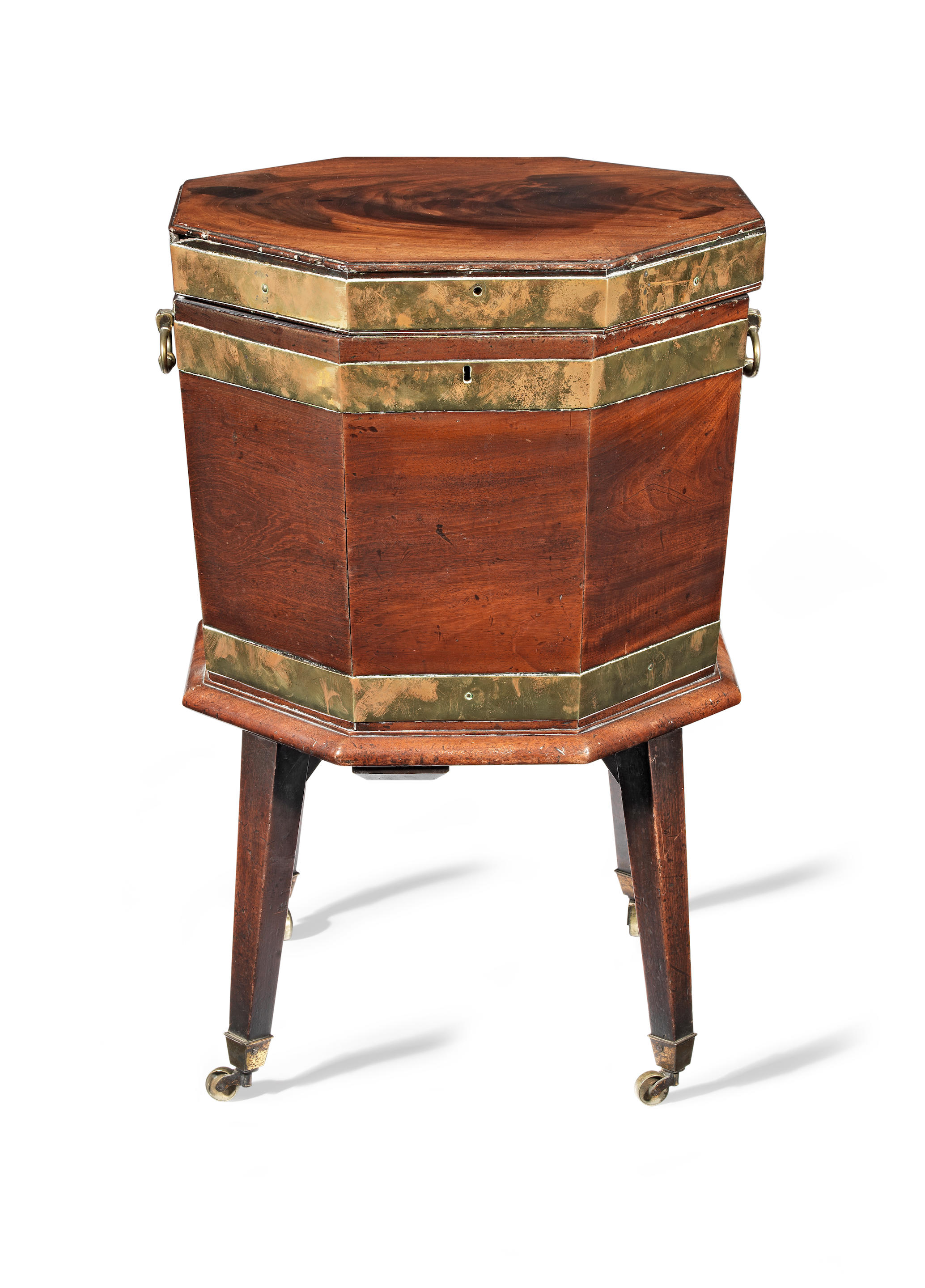 A LATE GEORGE III MAHOGANY AND BRASS MOUNTED OCTAGONAL CELLARET