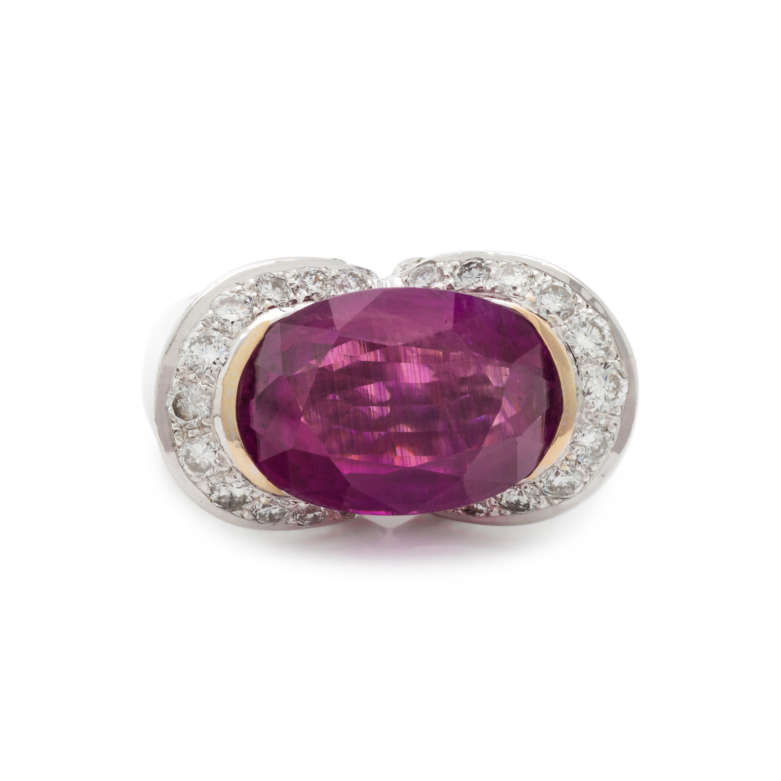 RUBY AND DIAMOND RING Containing one oval mixed cut ruby