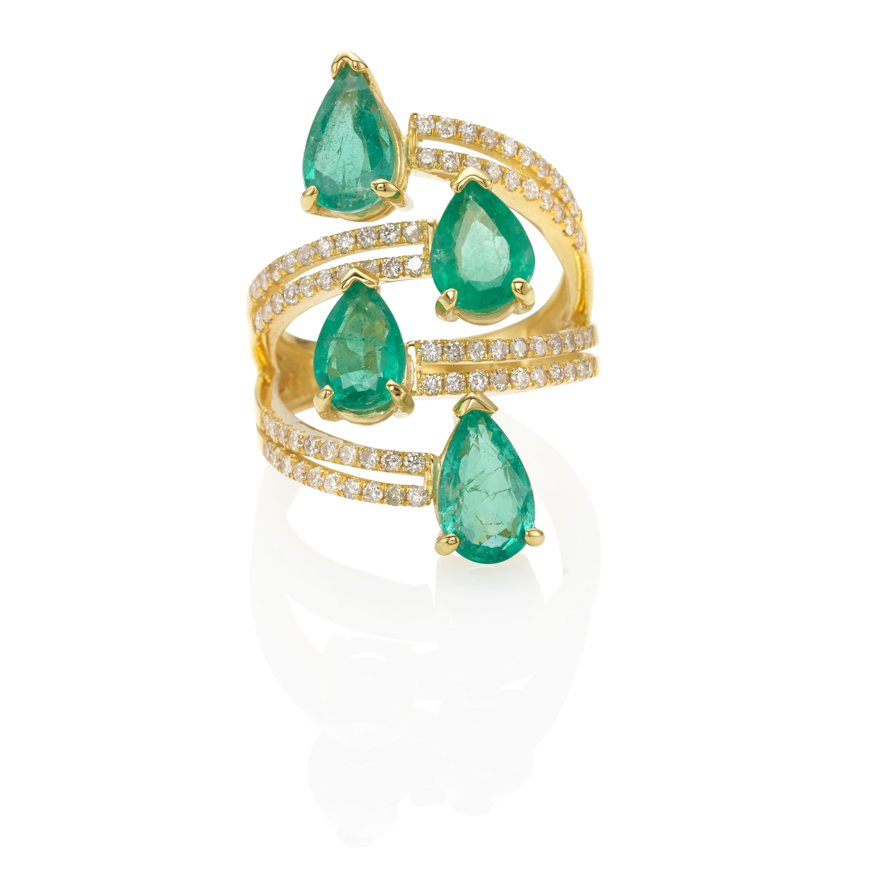 A GOLD EMERALD AND DIAMOND RING Of a stacked bypass
