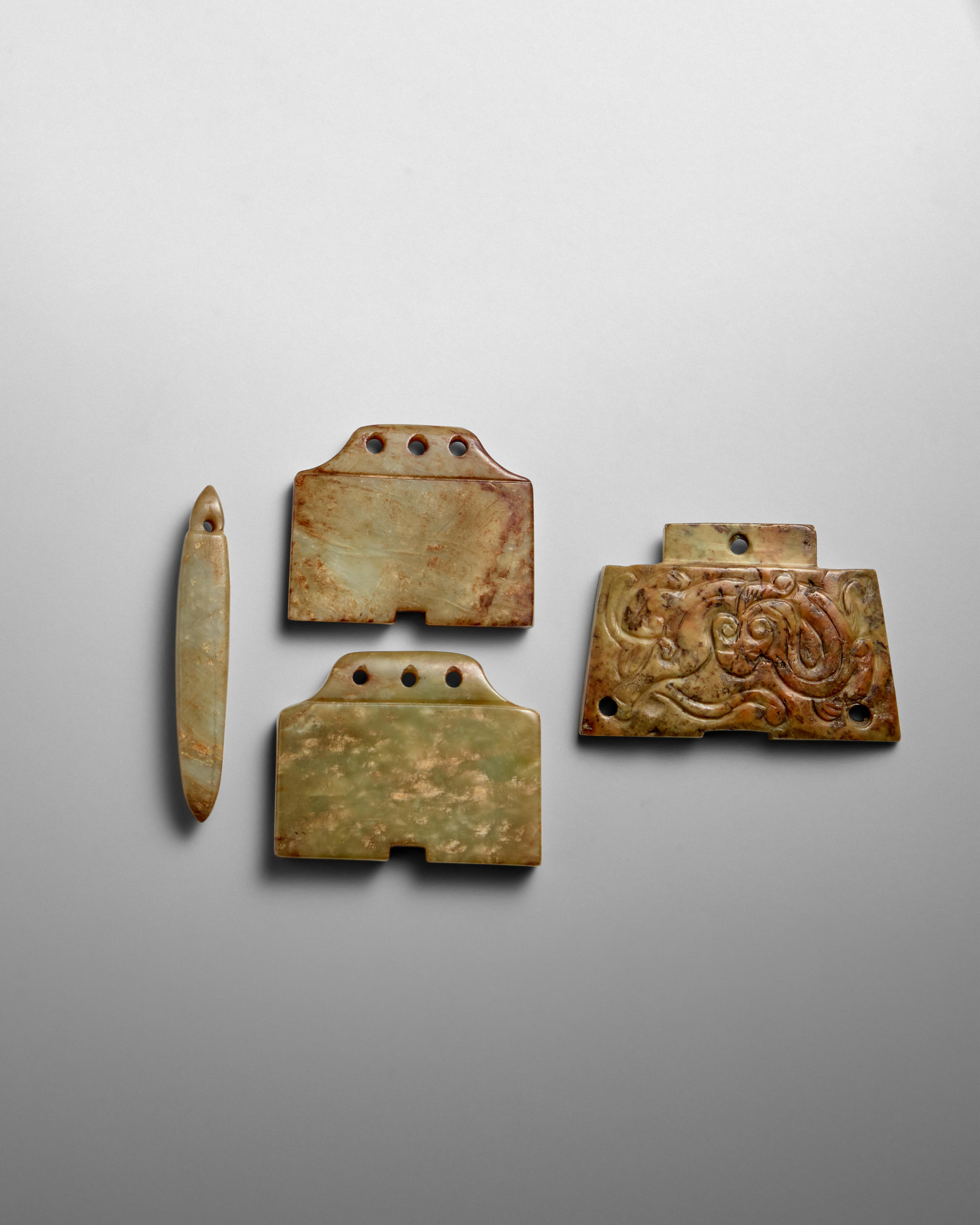 TWO ARCHAISTIC LIANGZHU STYLE JADE CARVINGS Late Qing Dynasty Possibly