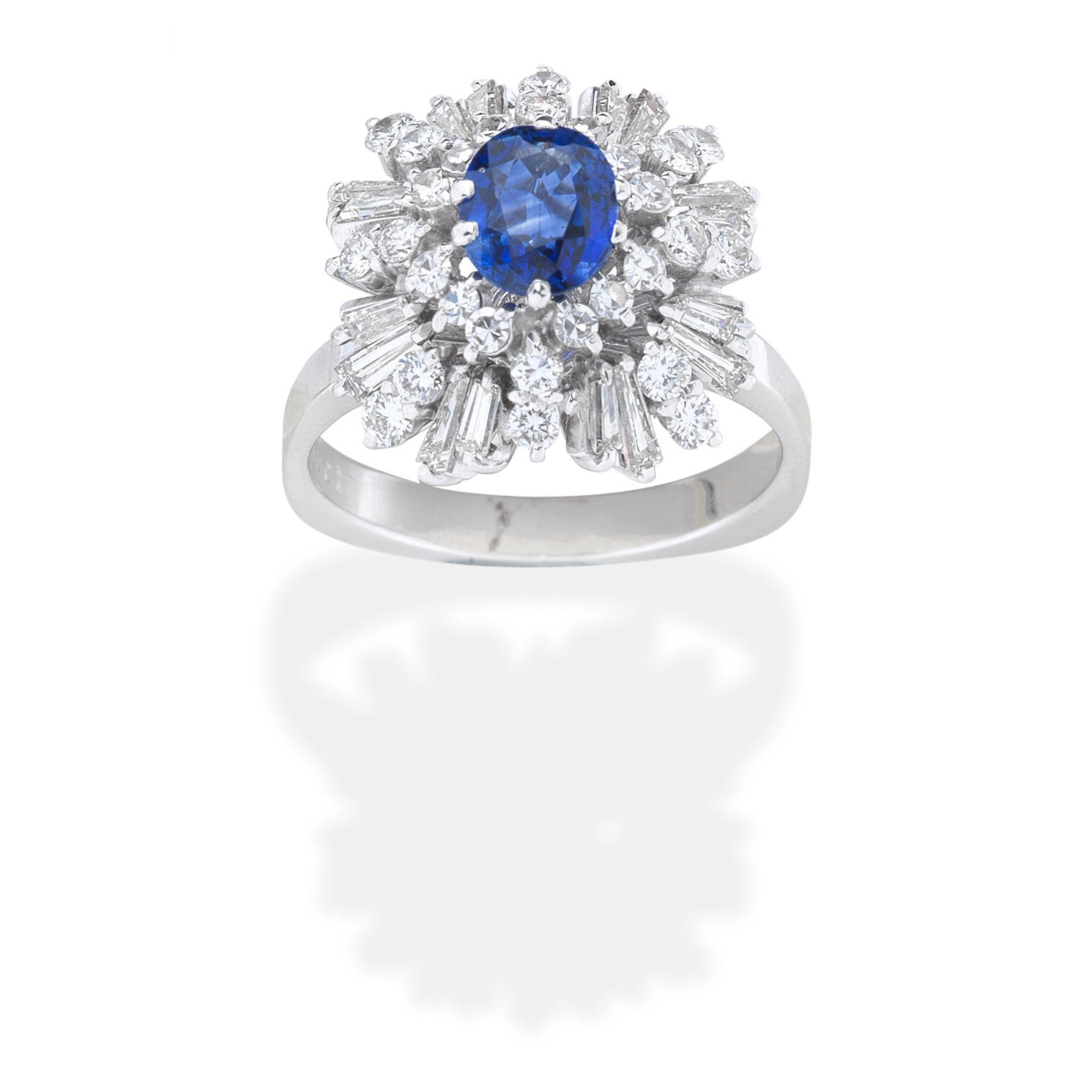 SAPPHIRE AND DIAMOND CLUSTER RING The oval cut sapphire within