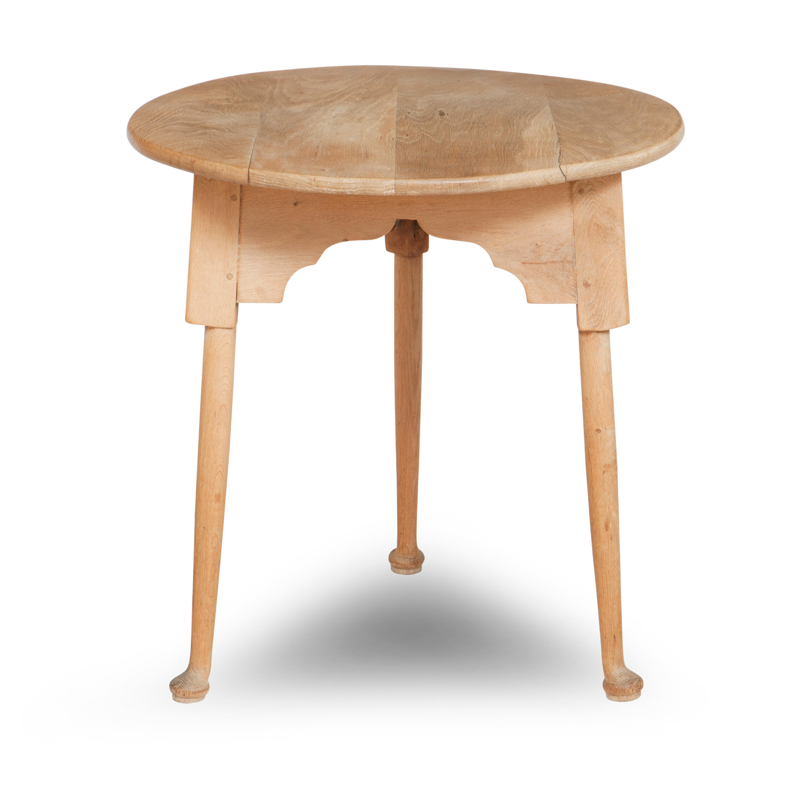 A BLEACHED ELM OCCASIONAL TABLE With a near circular top