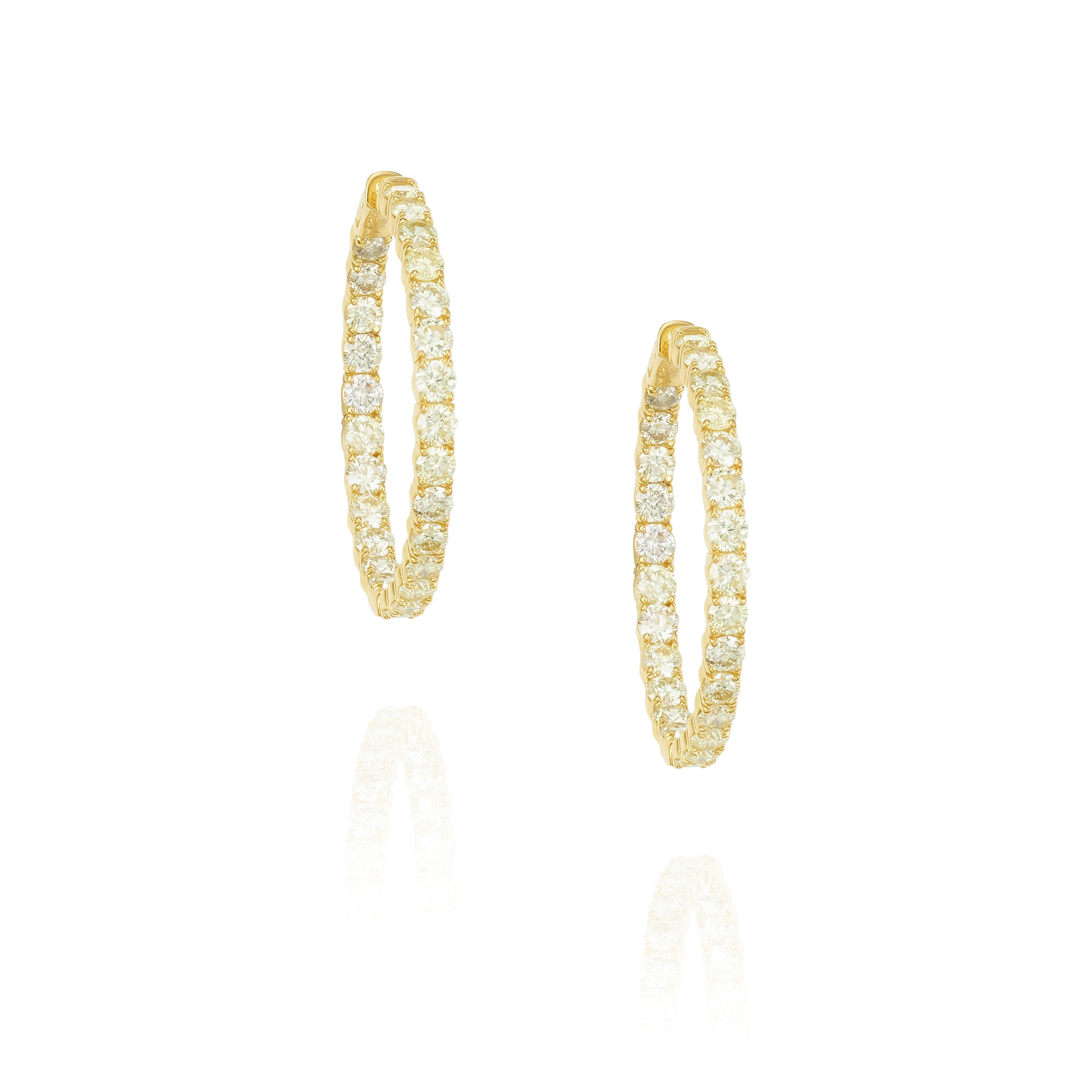 A PAIR OF 14K GOLD AND DIAMOND EARRINGS Featuring round