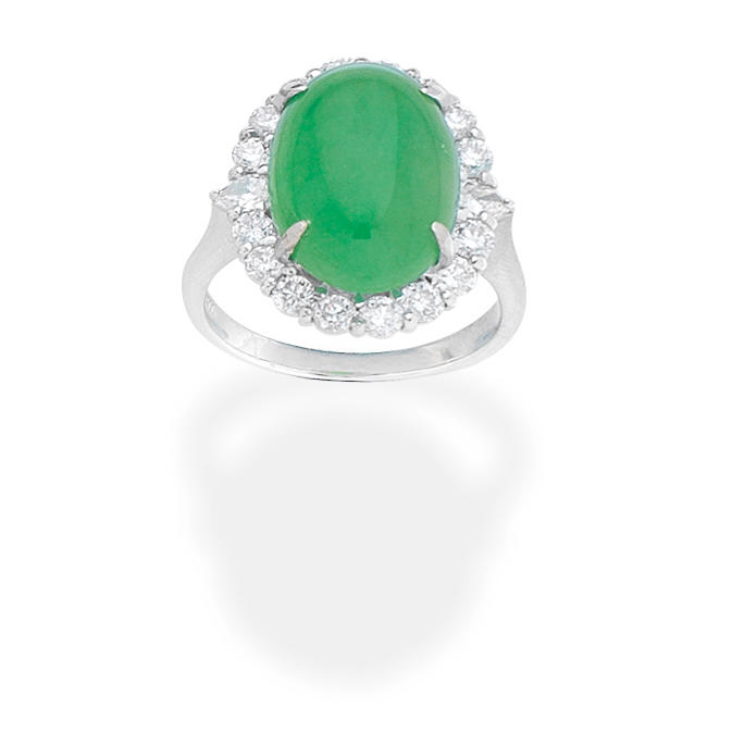 JADE AND DIAMOND RING The oval jadeite jade cabochon within