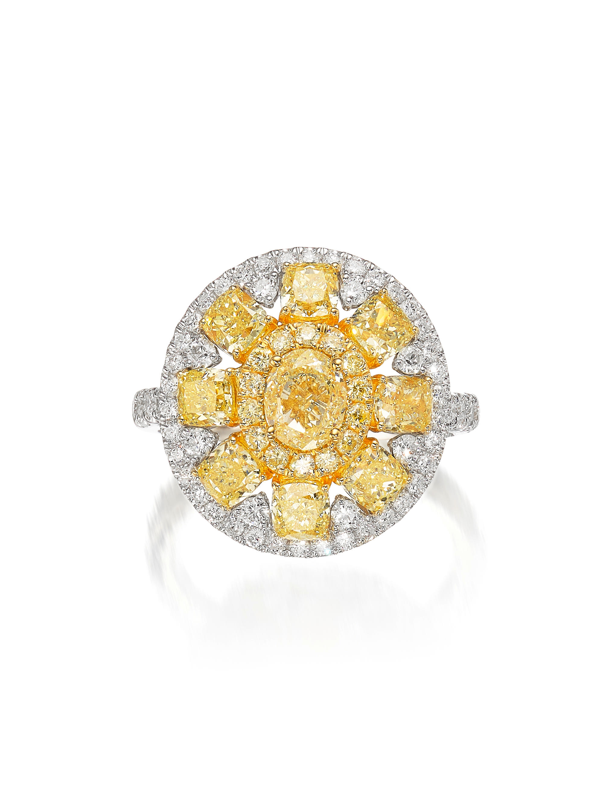 COLOURED DIAMOND AND DIAMOND RING Centring on an oval diamond