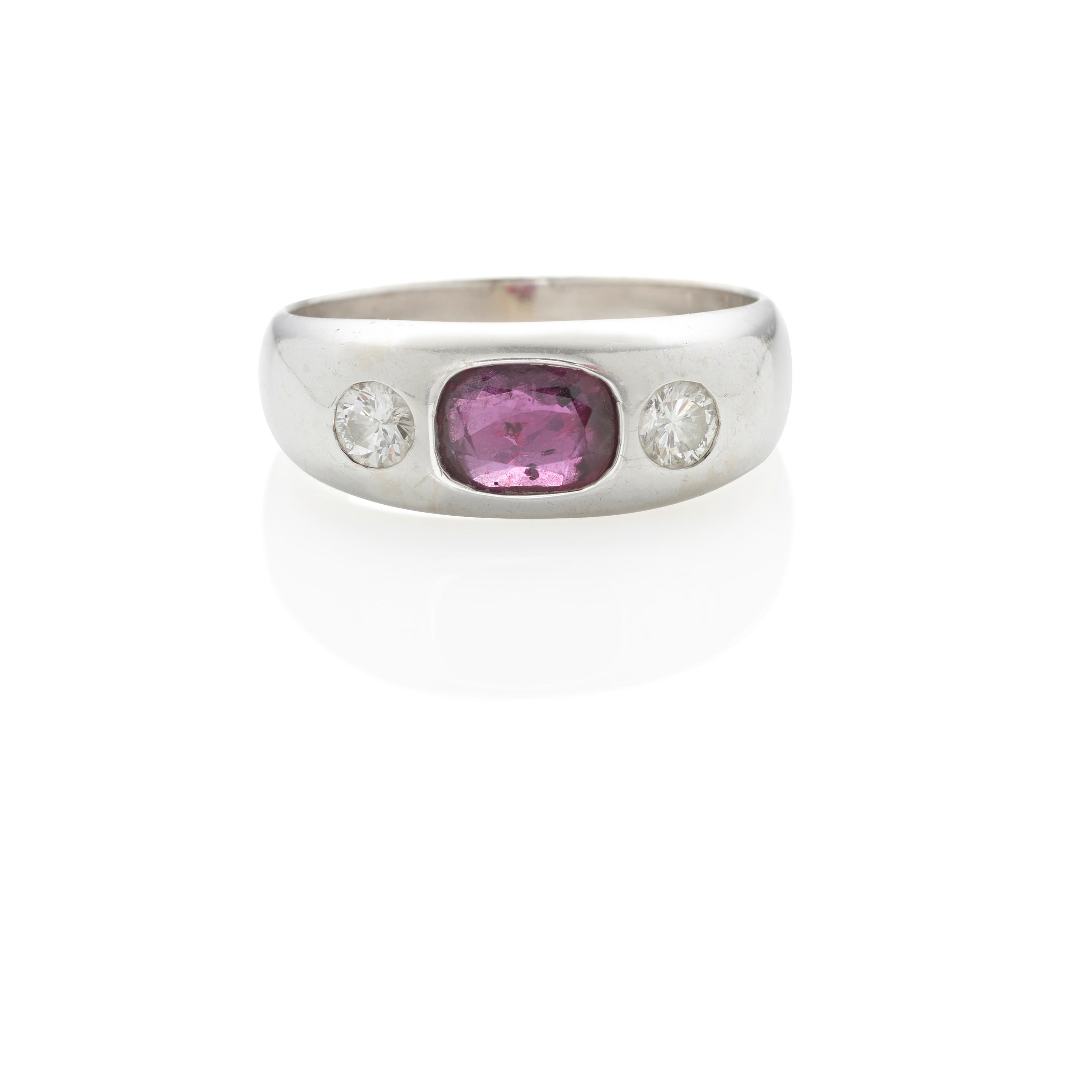 A RUBY AND DIAMOND RING Centering a flush set oval