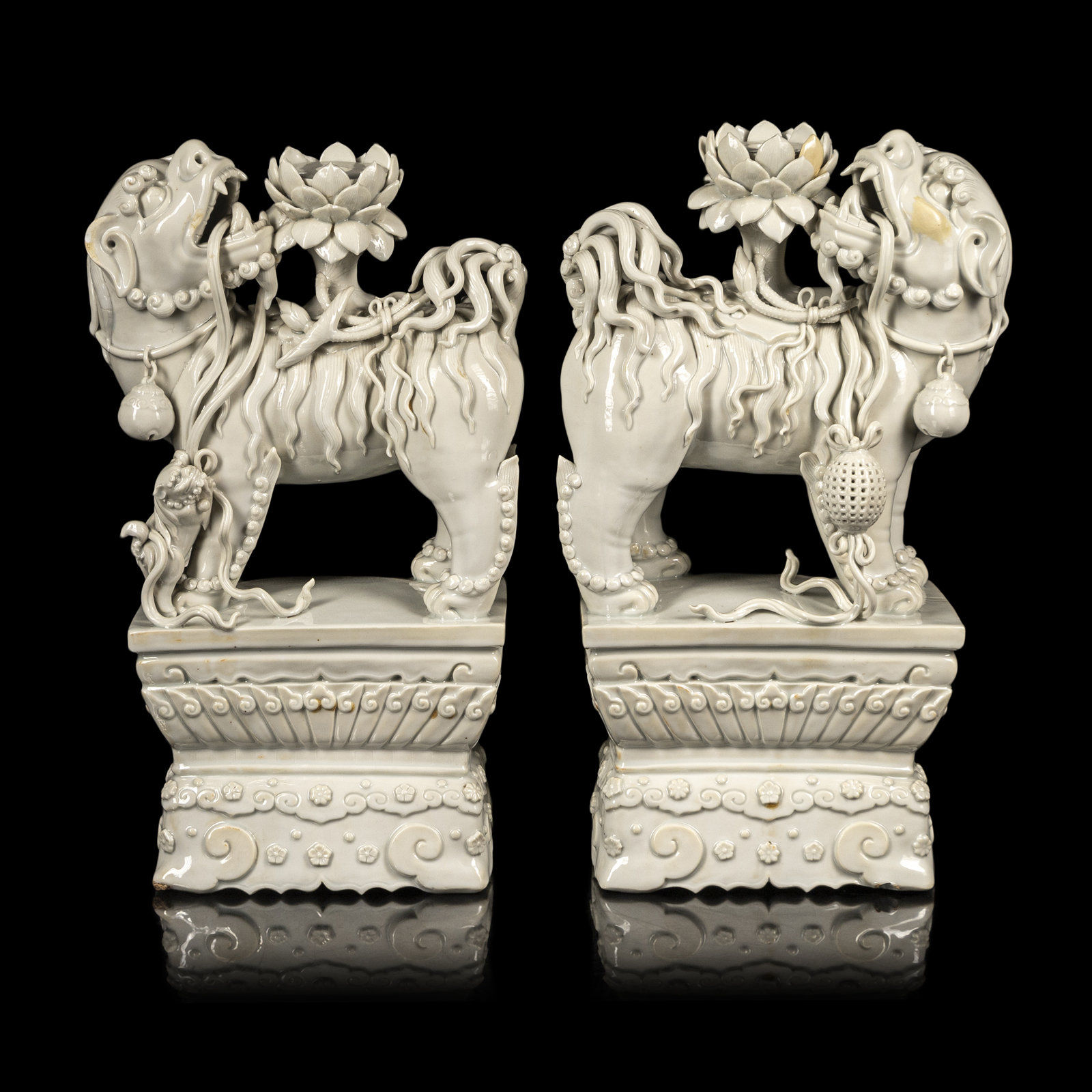A Pair of Chinese Blanc de Chine Figures of Fu