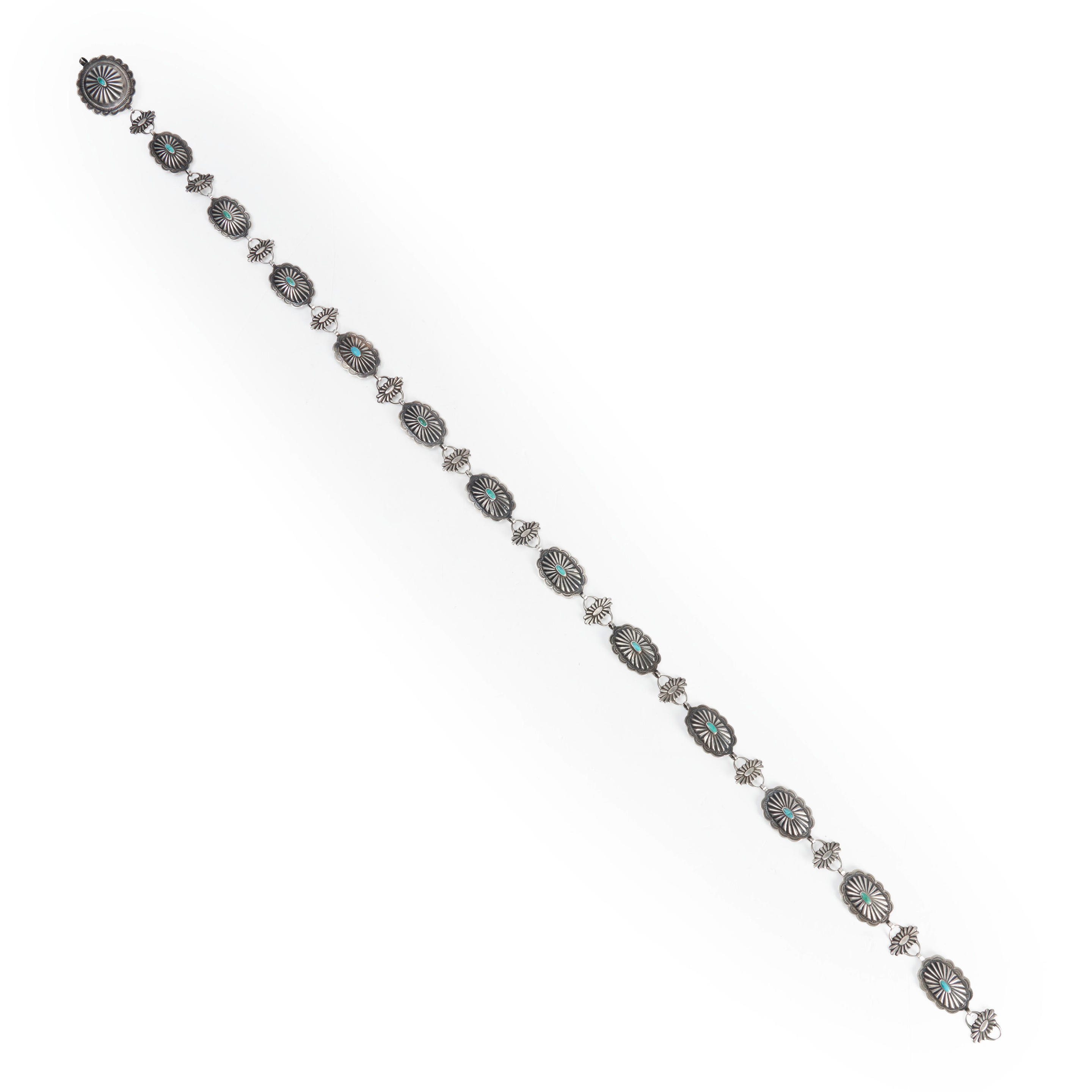 A DIN NAVAJO SILVER AND TURQUOISE CONCHA BELT Twelve oval